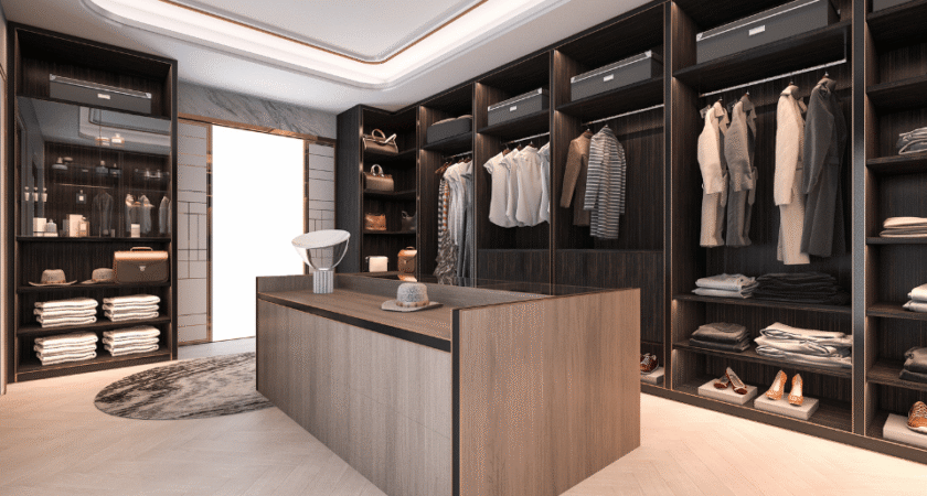 Walk-in closet with dark wood shelving and a center island