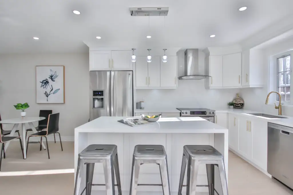 Affordable kitchen remodel in Bellevue with white cabinets and a center island
