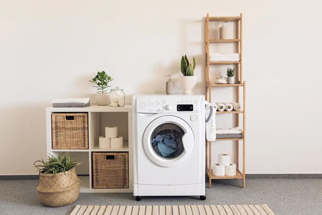 Laundry room remodel in Bellevue with stacked shelving and front-load washer