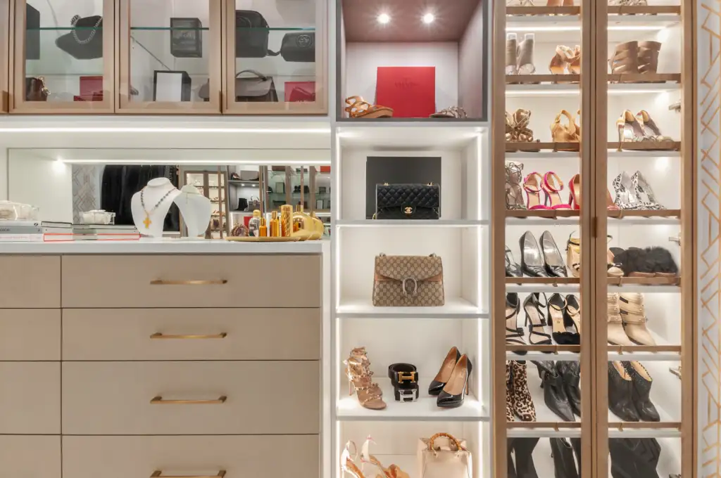 Custom walk-in closet with built-in shelving next to reach-in closets in a Bellevue bedroom